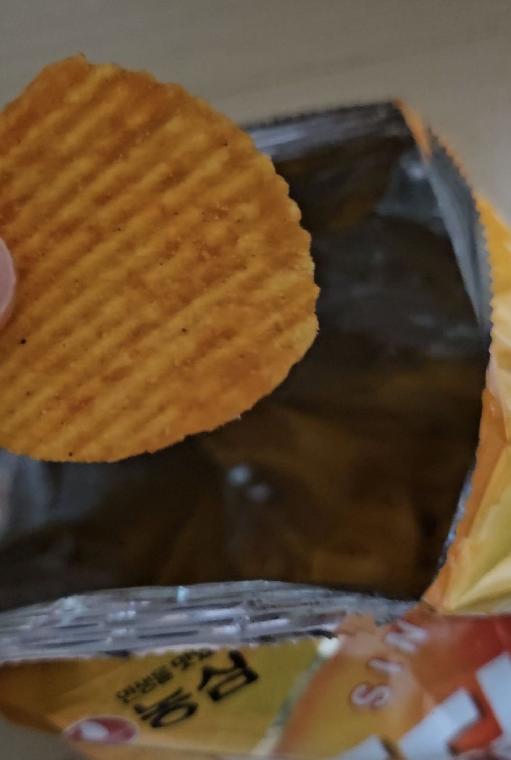 A bag of Nongshim Potato Chip K-Yangnyeom Chicken flavour, since 1980