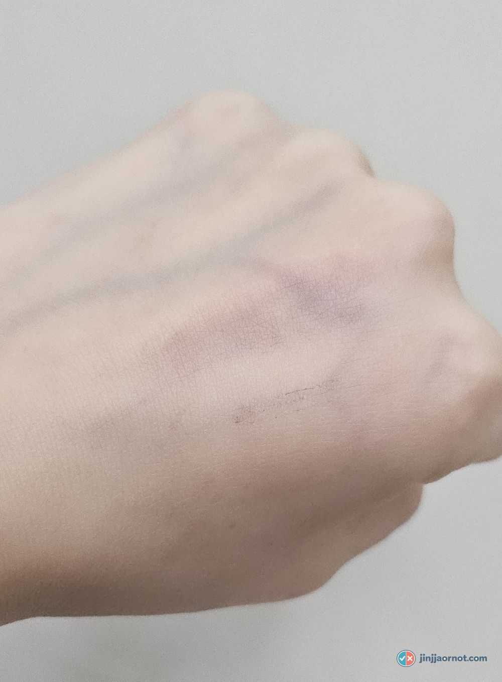 Back of a hand after rinsing with the Anua foam, showing light pink and a faint dark trace