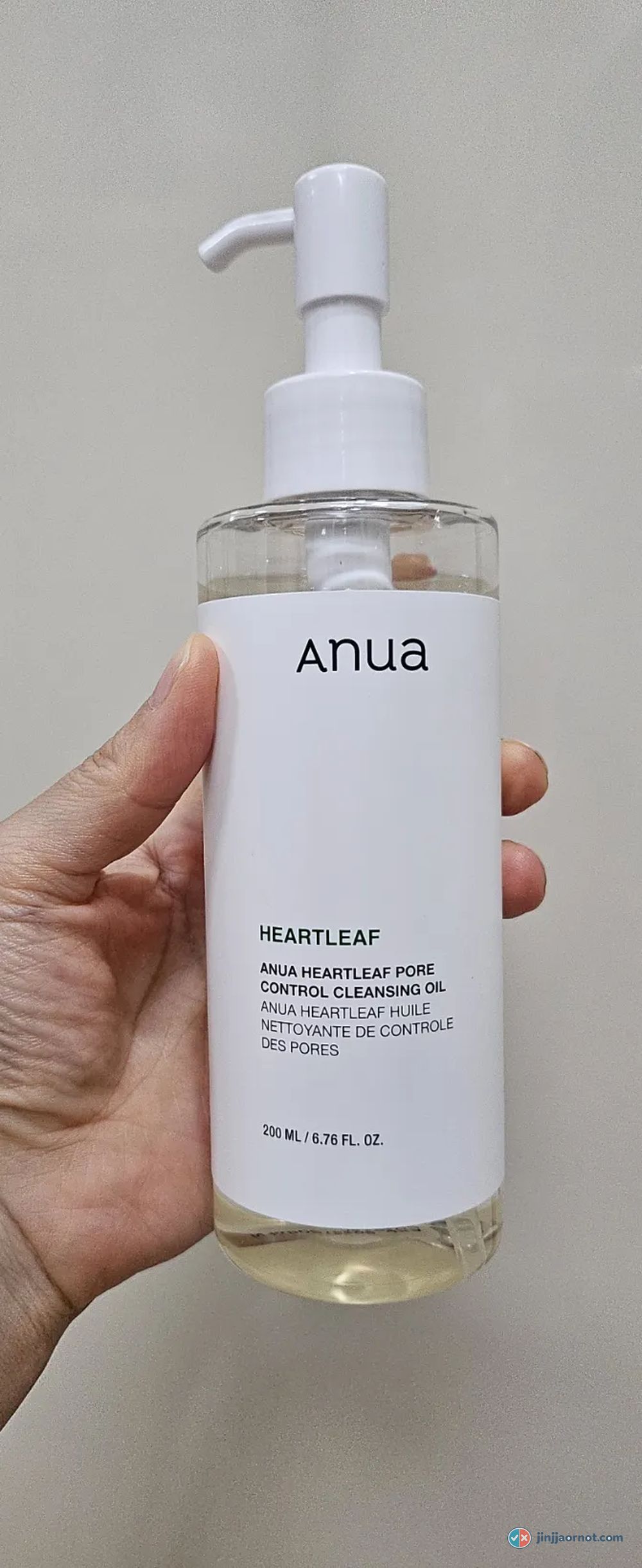 Anua Heartleaf Pore Control Cleansing Oil bottle held in hand