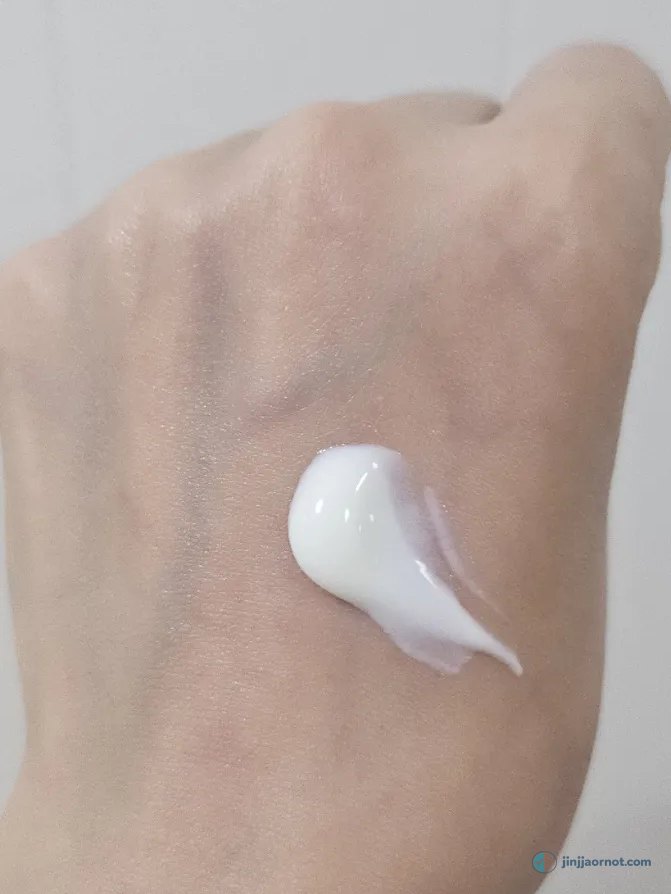 A dot of Round Lab Birch Juice sunscreen squeezed onto the back of my hand before rubbing in