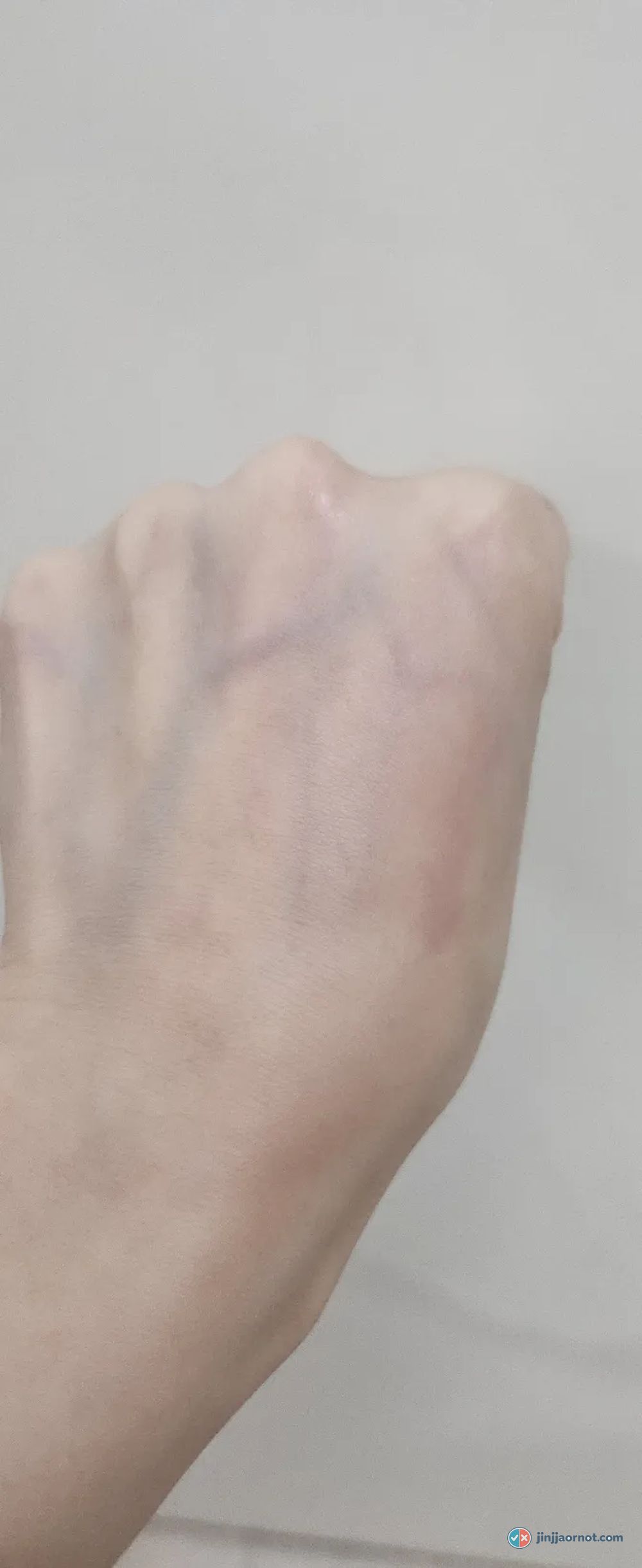 Back of a hand after rinsing with the BIOHEAL BOH cleanser, showing very faint pink marks