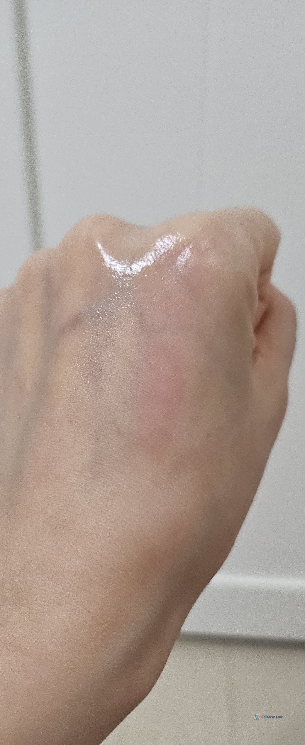 Beauty of Joseon Radiance Cleansing Balm rubbed out on the back of a hand, melted to a thin glossy film