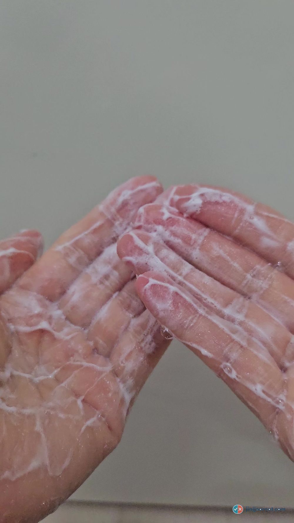 Hands covered in thick white lather from the Beauty of Joseon Green Plum cleanser