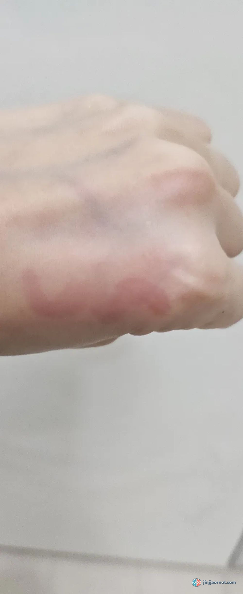 Back of a hand after rinsing with the Beauty of Joseon Green Plum cleanser, showing the most remaining pink