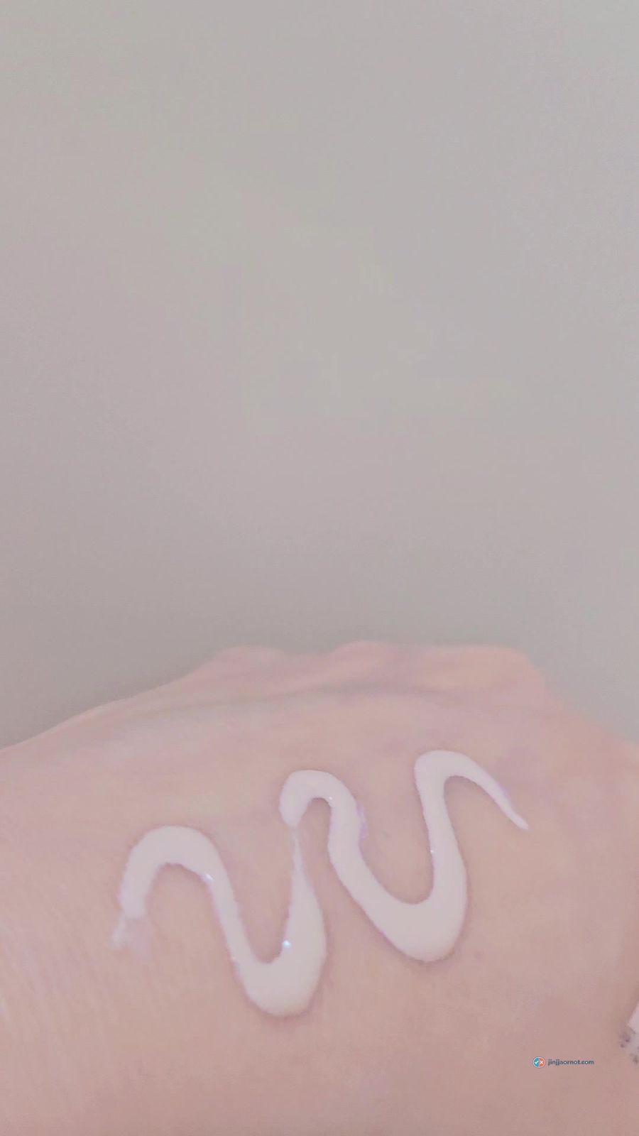 A squiggle of Beauty of Joseon Daily Tinted Fluid Sunscreen dispensed on the back of a hand
