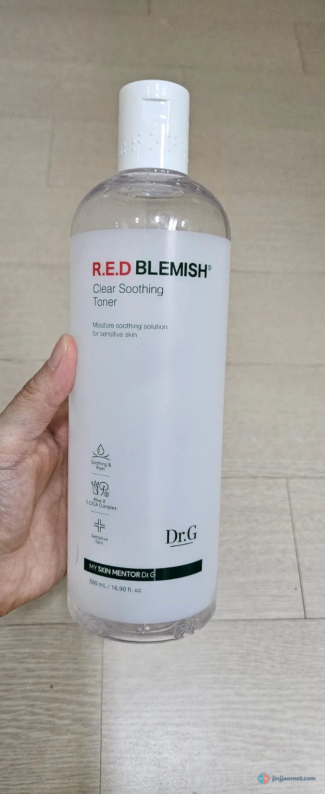 A 500ml bottle of Dr.G R.E.D Blemish Clear Soothing Toner held in hand