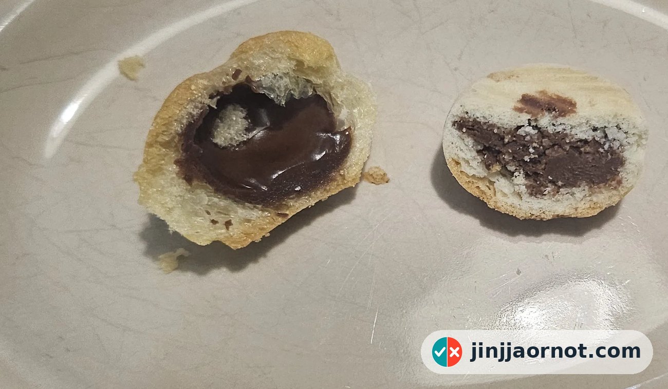 Home Run Ball and Kancho cut in half side by side, showing the airy chocolate cream versus the firm cookie with chocolate center