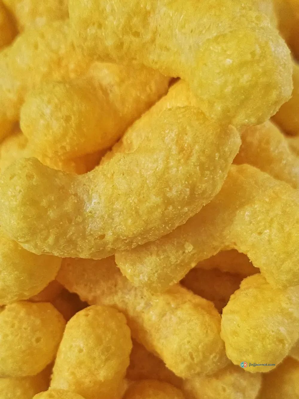 Mango Kick corn puffs in a white bowl