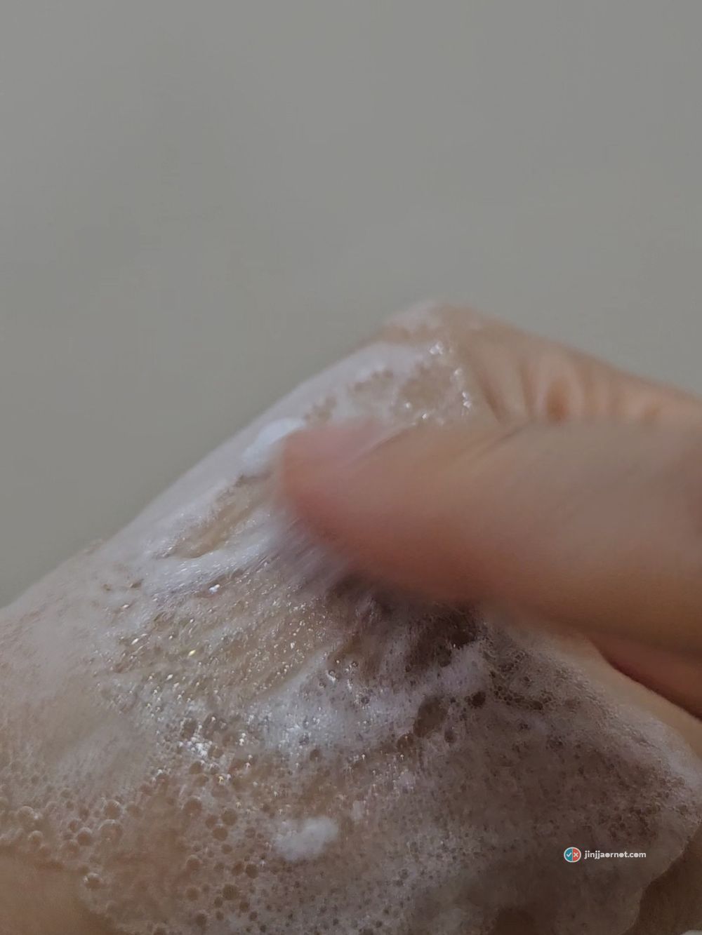 A dense layer of fine foam covering the back of a hand