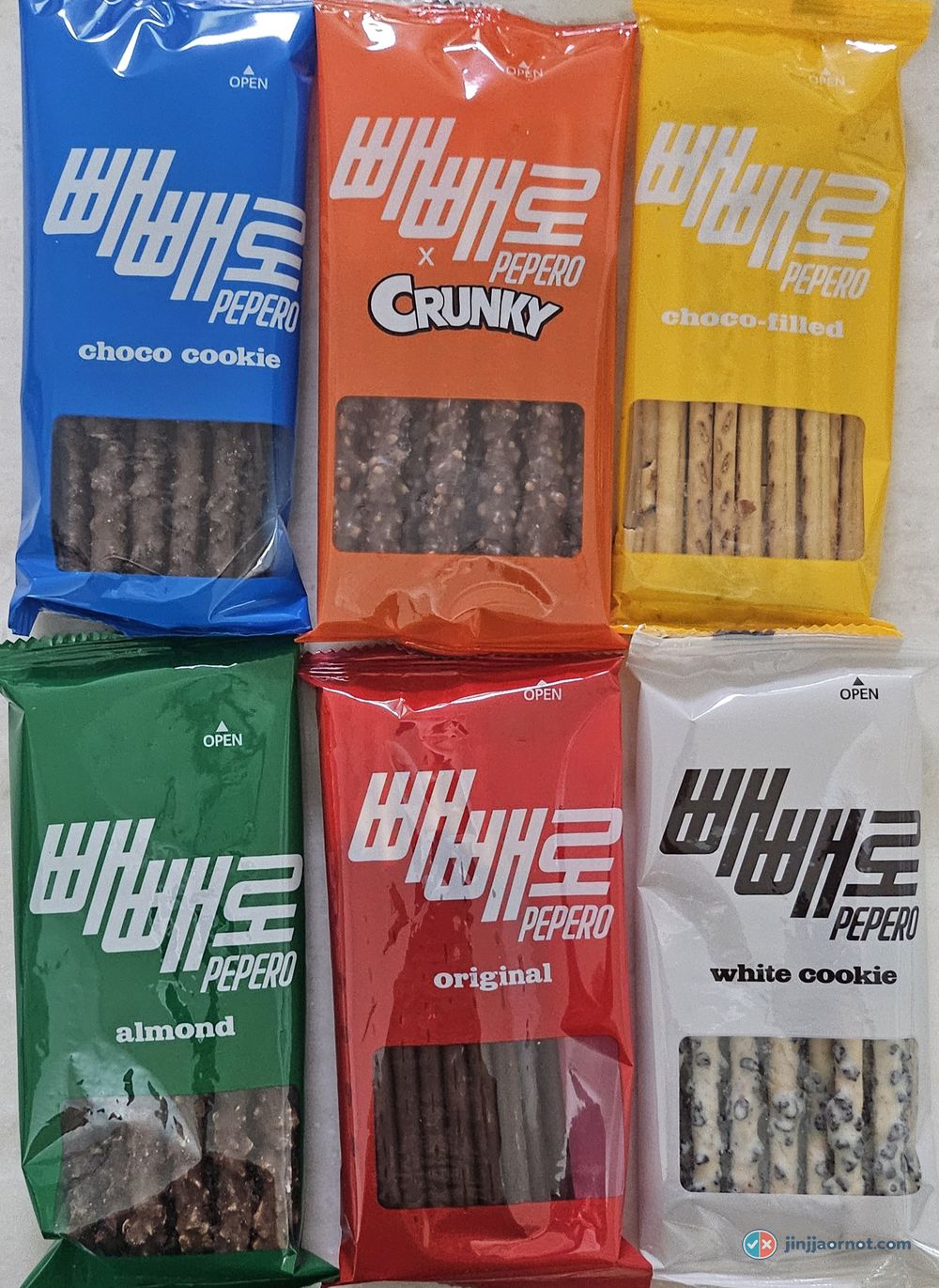 Six Pepero flavors in their individual wrappers, laid out on a table — my own photo