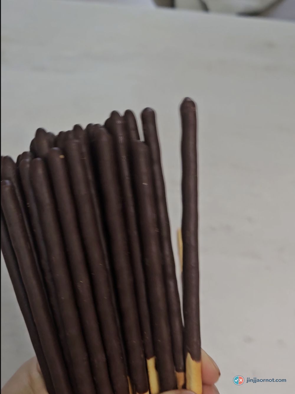 Strawberry Pepero sticks up close, showing the pink coating with visible dried strawberry pieces
