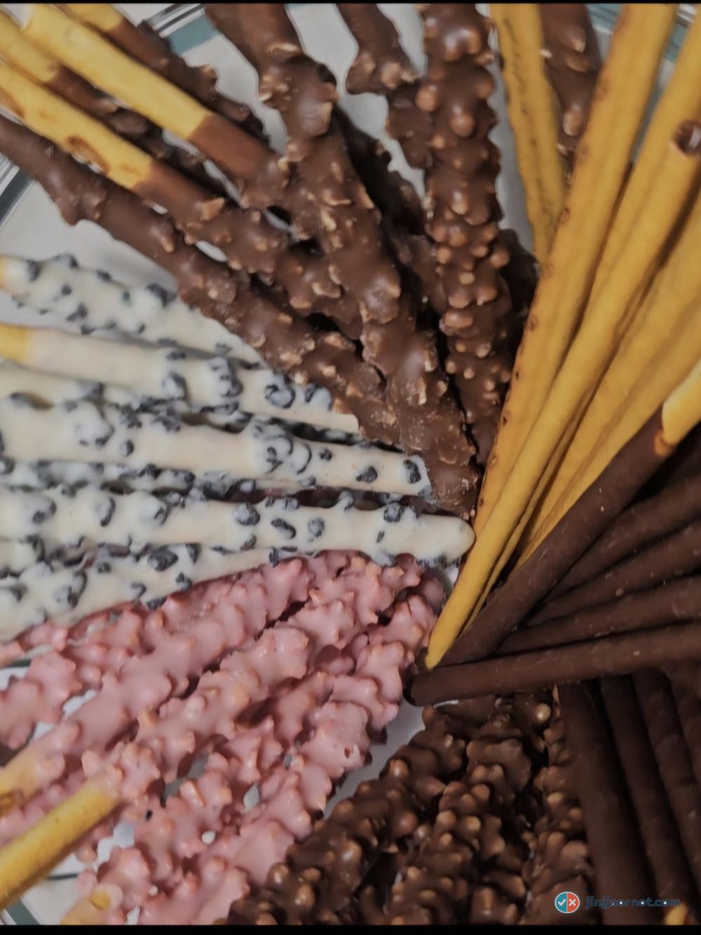 White Cookie Pepero sticks close up, white coating with dark cookie flecks