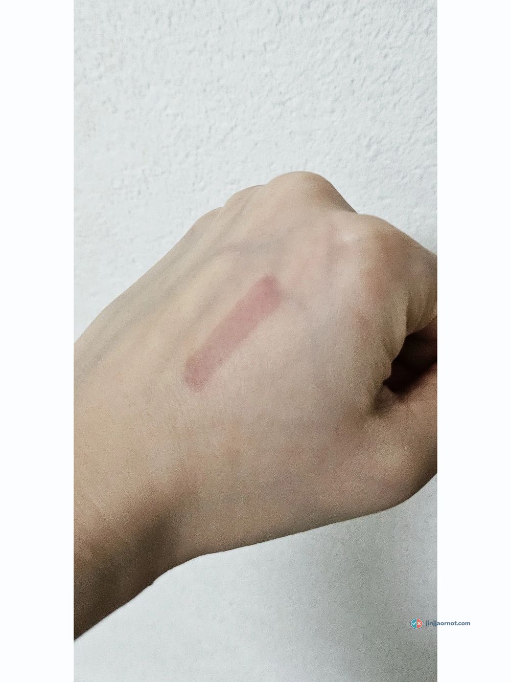 Faint pink tint stain remaining on skin after cleansing milk was wiped away