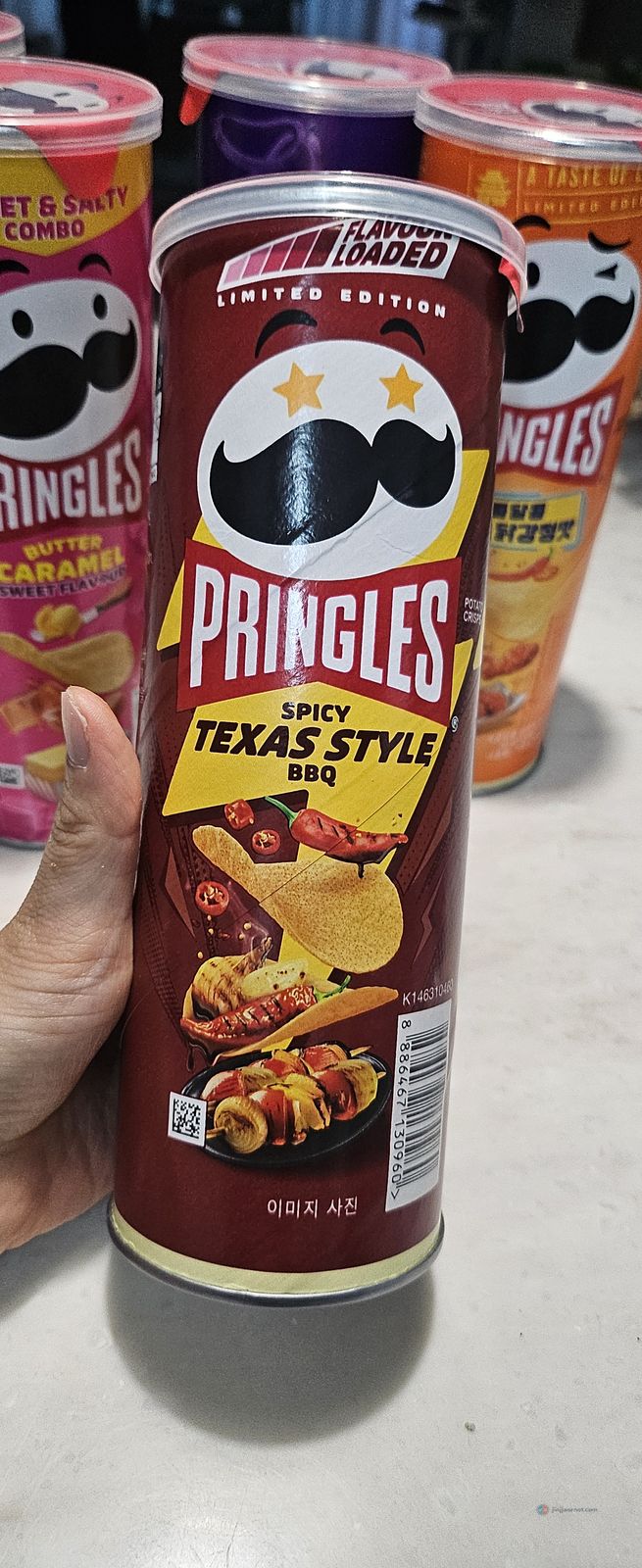A can of Pringles Spicy Texas Style BBQ, limited edition, held in hand
