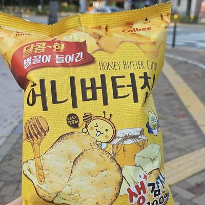 Haitai Honey Butter Chip bag, held on a Korean street